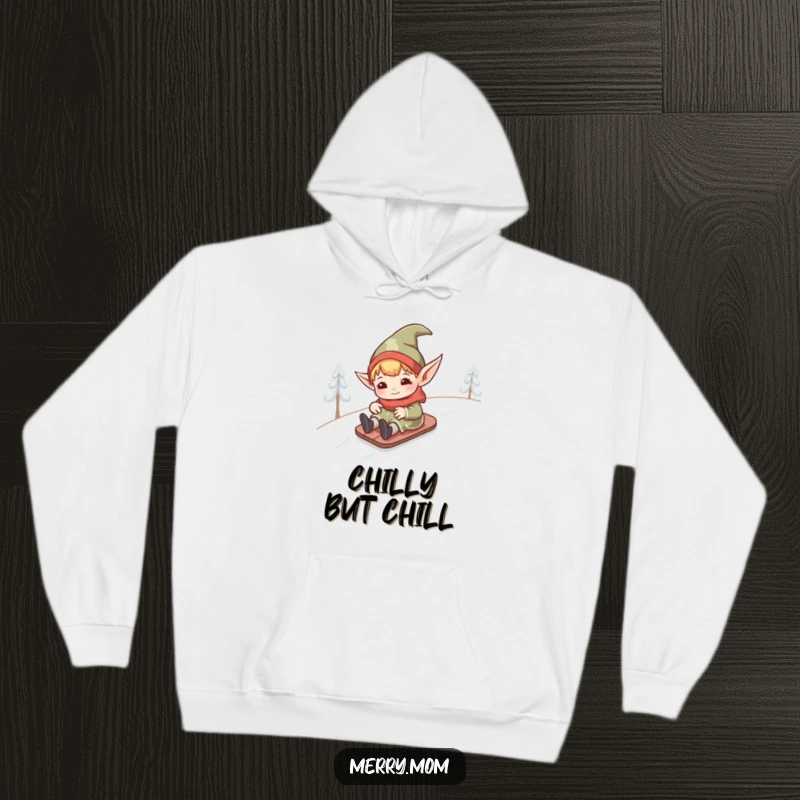 Funny kawaii elf with pointed ears sliding down a snowy hill, depicted on a cozy hoodie for ultimate winter fun.