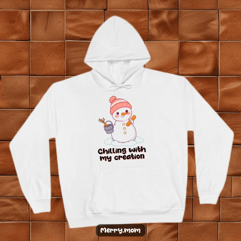 Funny animal focused on building a snowman with a bucket and carrot, featured on a warm hoodie for winter fun.