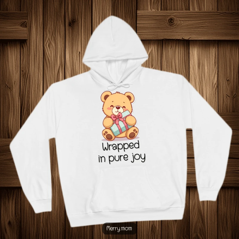 Funny hoodie with a kawaii teddy bear hugging a wrapped present, offering cozy comfort and heartwarming charm.