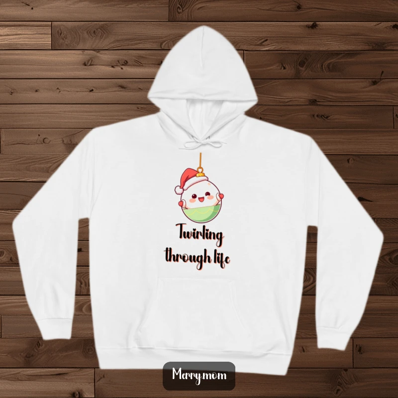 Funny hoodie showcasing a cute Kawaii Christmas ornament character happily spinning, perfect for cozy holiday moments.
