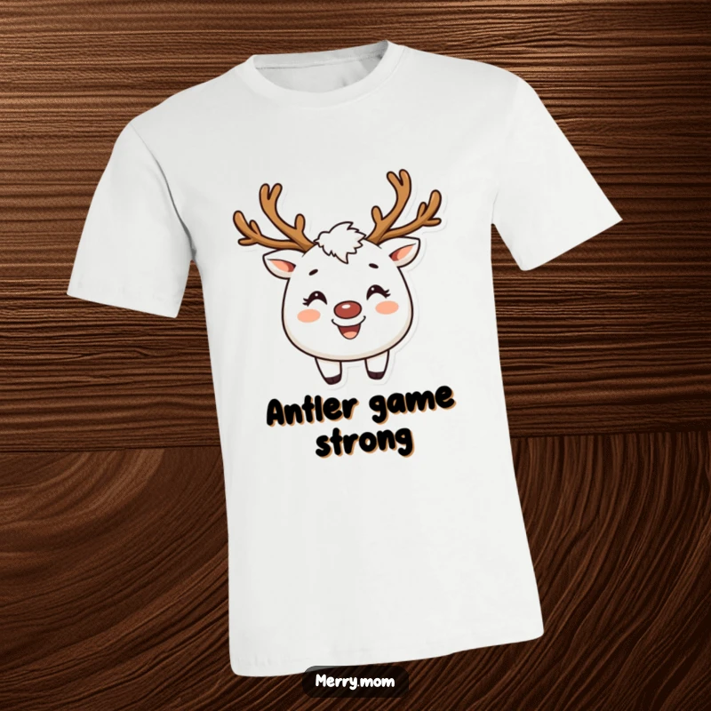 Funny t-shirt of a creature with reindeer antlers and a broad smile, personifying Christmas joy and spirit.